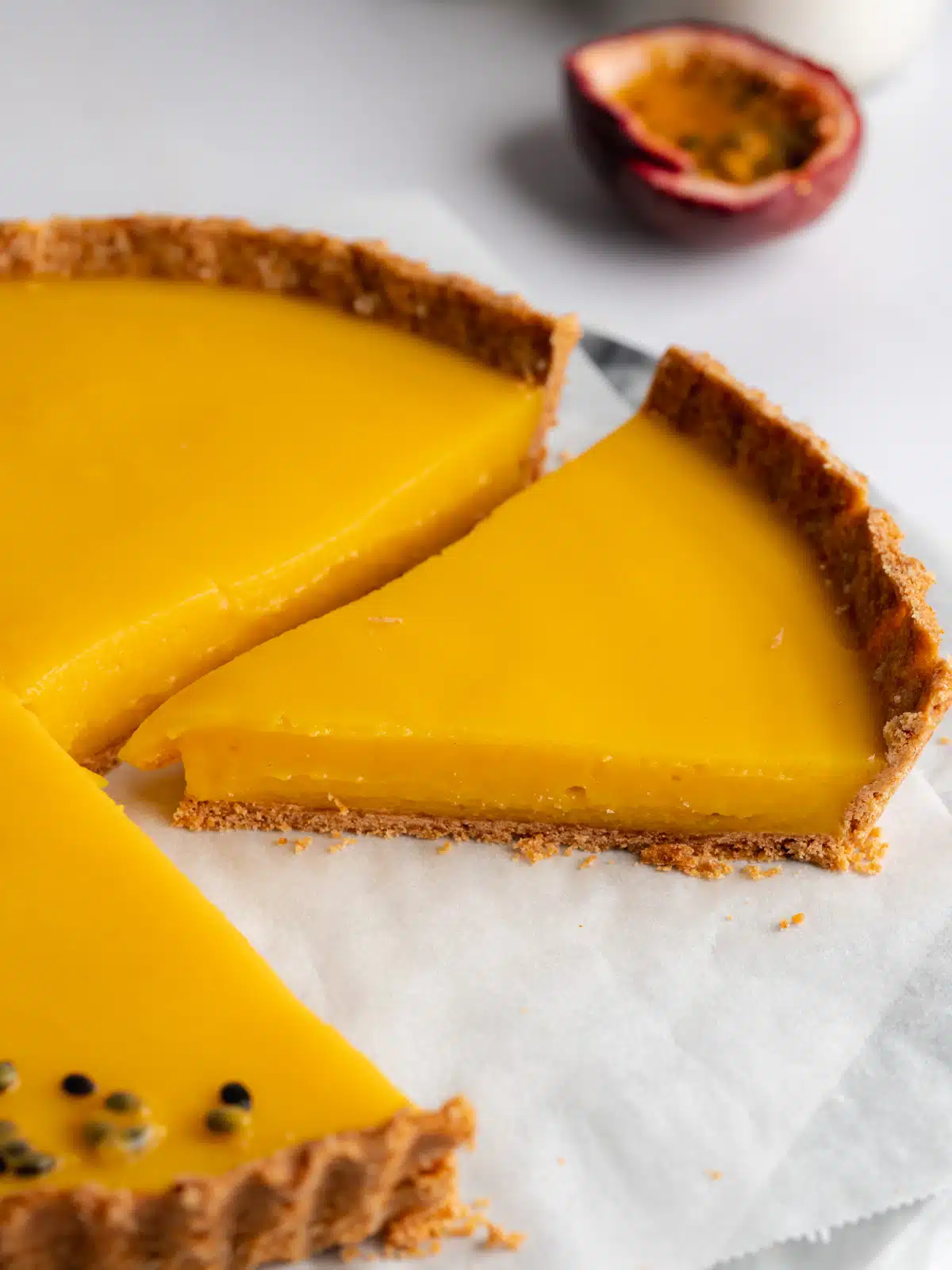 a passion fruit tart that's been sliced into servings.